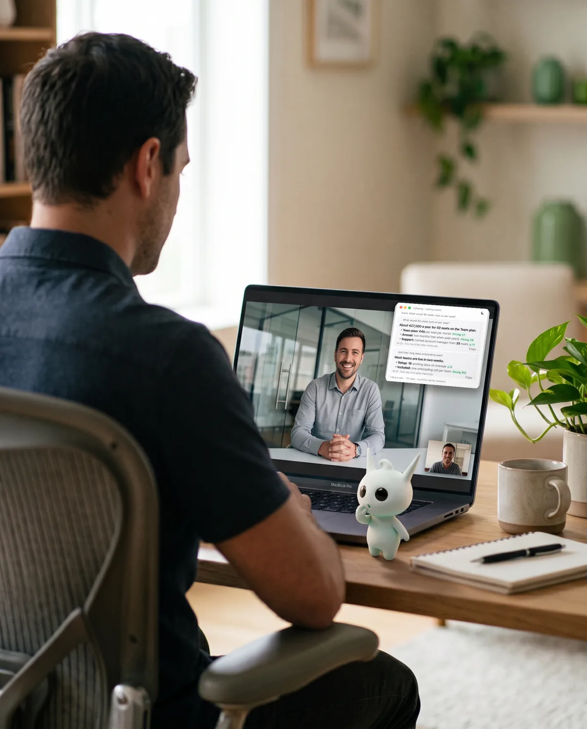 A person on a video call at a home desk; Murmury's answer window sits on the laptop screen and the small white elf stands by the keyboard.